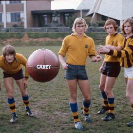 Members of football team posing for photograph on the Sandell Oval, 1974