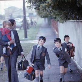 Parent dropping junior boys at school, 1974